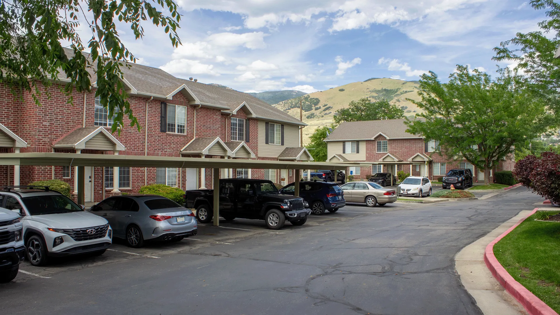 Woodside Creek Townhomes exterior view showcasing covered parking and modern design in Bountiful